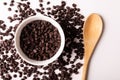 Overhead view of fresh chocolate chips with bowl and wooden spoon on white background Royalty Free Stock Photo