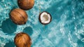 Overhead view of fresh coconuts floating in a summer swimming pool