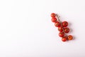 Overhead view of fresh red cherry tomatoes twig by copy space over white background Royalty Free Stock Photo