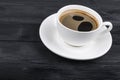 Overhead view of a freshly brewed mug of espresso coffee on black rustic wooden background with woodgrain texture. Coffee break Royalty Free Stock Photo