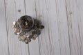 Overhead view of a glass mason jar full of coins on a wood slat surface