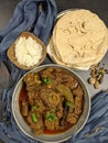 Overhead view of Goat curry, Mutton curry, Nihari, Rogan Josh in a bowl with Chapati and plain Rice