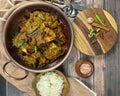 Overhead view of Goat curry, Mutton curry, Nihari, Rogan Josh in a bowl with Chapati and plain Rice