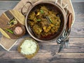 Overhead view of Goat curry, Mutton curry, Nihari, Rogan Josh in a bowl with Chapati and plain Rice