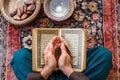 Person Holding Quran and Prayer Beads Royalty Free Stock Photo