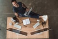 overhead view of handsome young programmer using laptop and smiling Royalty Free Stock Photo