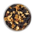 Overhead view of high energy trail mix with roasted nuts and fruit in a colorful bowl isolated on a white background Royalty Free Stock Photo