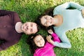 Family Relaxing On Grass At Park Royalty Free Stock Photo