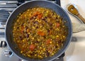 Overhead view of homemade cooked chili food on top of natural gas stove Royalty Free Stock Photo