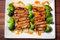 overhead view of juicy teriyaki-marinated tofu steaks on a white plate