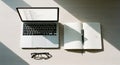 Workspace with Laptop, Notebook, and Glasses Royalty Free Stock Photo