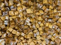 overhead view looking down at bulk pile of wrapped caramel candy treats Royalty Free Stock Photo