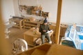 Overhead view on man carpenter sitting on table at modern joinery workshop