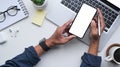 Top view man using smart phone at white office desk. Royalty Free Stock Photo