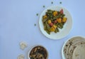 Overhead view of matar paneer veg, mashroom soup and roti Indian food over white background, with copy space