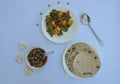 Overhead view of matar paneer veg, mashroom soup and roti Indian food over white background, with copy space
