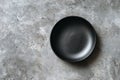 Empty Black Plate on Concrete Background Royalty Free Stock Photo