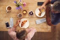 Overhead View Of Mature Couple In Coffee Shop Meeting Up In Socially Distanced Way Royalty Free Stock Photo