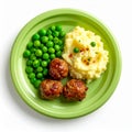 Overhead View of Meatballs Mashed Potatoes and Green Peas on Green Plate Royalty Free Stock Photo