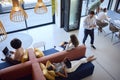 Overhead View Of Modern Open Plan Office With Staff Working Around Table And Breakout Seating Area Royalty Free Stock Photo