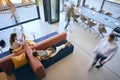 Overhead View Of Modern Open Plan Office With Staff Working Around Table And Breakout Seating Area Royalty Free Stock Photo