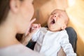 Overhead View Of Mother Cuddling Yawning Newborn Baby Son At Home Royalty Free Stock Photo