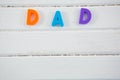 Overhead view of multi colored dad text on white table