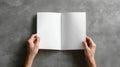 Overhead View: Open Blank Notebook Held by Hands on Gray Textured Surface Royalty Free Stock Photo