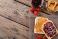Overhead view of open face peanut butter and jelly sandwich on napkin with jars and strawberries Royalty Free Stock Photo