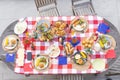 Overhead view of outdoor chairs and dining table set with american flags and celebration meal Royalty Free Stock Photo