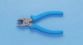 Overhead View of Blue Handle Wire Cutters on a Light Blue Background pliers tool Royalty Free Stock Photo
