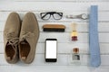 Overhead view of personal accessories on white table