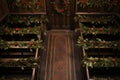 an overhead view of pews lined with holly wreathes