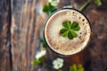 overhead view of a pint of beer with a lucky irish clover. St Patrick's day drink Royalty Free Stock Photo