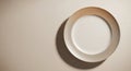 Overhead View of a Plain White Ceramic Plate with a Subtle Textured Rim on a Neutral Background Royalty Free Stock Photo