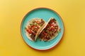 Overhead view of a plate of fresh mexican tacos on a bright color background