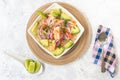 Plate of shrimp ceviche with avocado on a white table