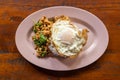 Overhead view of Prad Ka Pao, popular Thai steet food made up of fried minced pork with basil and fried egg with rice Royalty Free Stock Photo