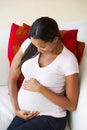 Overhead View Of Pregnant Woman Relaxing On Sofa Royalty Free Stock Photo