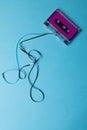 Overhead view of purple cassette tape with copy space on blue background Royalty Free Stock Photo