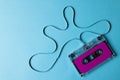 Overhead view of purple cassette tape with copy space on blue background Royalty Free Stock Photo