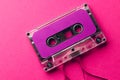 Overhead view of purple cassette tape on pink background Royalty Free Stock Photo