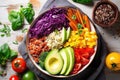 overhead view of a quinoa bowl with various brightly colored veggies