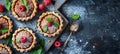 Overhead view of raspberry mini tart on white cutting board with vintage teaspoons Royalty Free Stock Photo