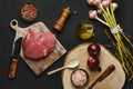 Overhead view of raw beef ball tip steak with ingredients on black background