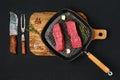 Overhead view of raw boneless beef loin steak on cast iron skillet Royalty Free Stock Photo