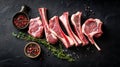 Overhead view of raw lamb chops and mutton cutlets on ribs against a dark backdrop for culinary art Royalty Free Stock Photo