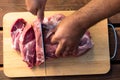 Overhead view of raw piece of pork on wooden background. Piece of fresh boneless pork, neck part or collar. Big piece of red raw m Royalty Free Stock Photo