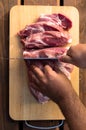 Overhead view of raw piece of pork on wooden background. Piece of fresh boneless pork, neck part or collar. Big piece of red raw m