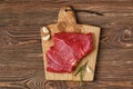 Overhead view of raw top side beef steak on wooden tabletop Royalty Free Stock Photo